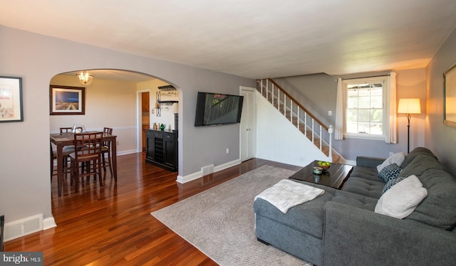 3004 Joshua Rd, Lafayette Hill, PA 19444 - living area featuring visible vents, arched walkways, stairway, baseboards, and dark wood-type flooring