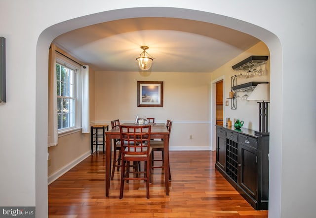 3004 Joshua Rd, Lafayette Hill, PA 19444 - dining area featuring baseboards, arched walkways, and wood finished floors