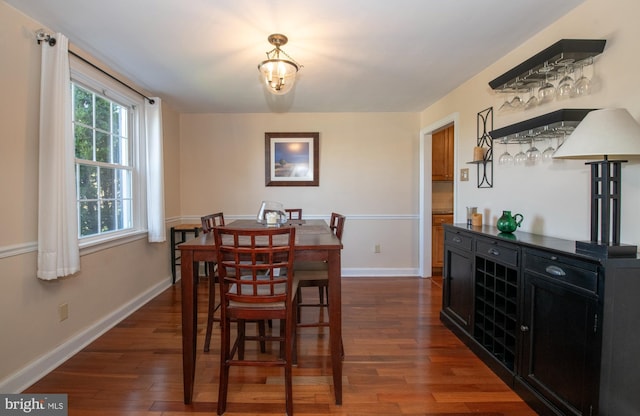 3004 Joshua Rd, Lafayette Hill, PA 19444 - dining space featuring baseboards, a bar, and dark wood-style flooring