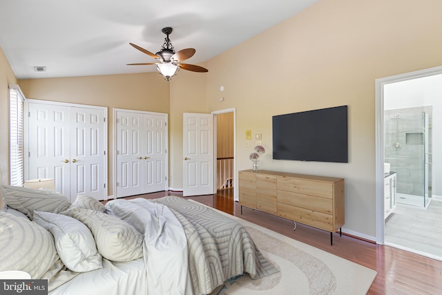5811 Summerlake Way, Centreville, VA 20120 - bedroom featuring visible vents, multiple closets, wood finished floors, connected bathroom, and vaulted ceiling