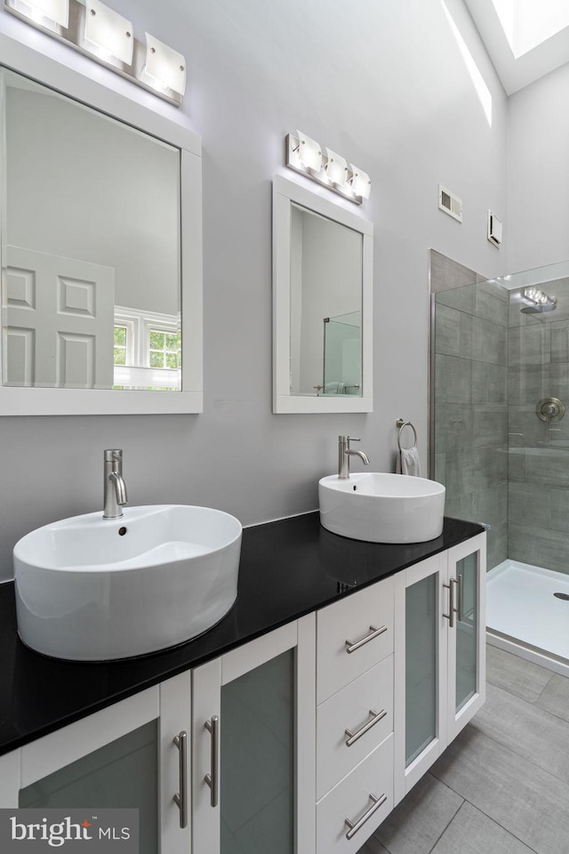 5811 Summerlake Way, Centreville, VA 20120 - bathroom featuring a sink, tiled shower, double vanity, and visible vents