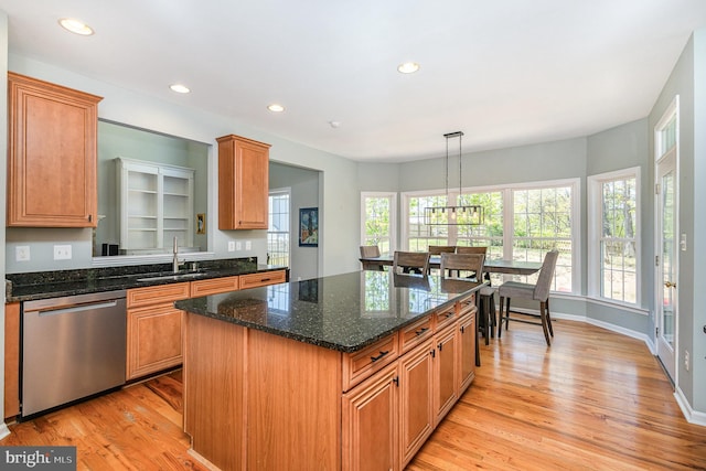 kitchen with a sink, recessed lighting, light wood finished floors, a chandelier, and stainless steel dishwasher