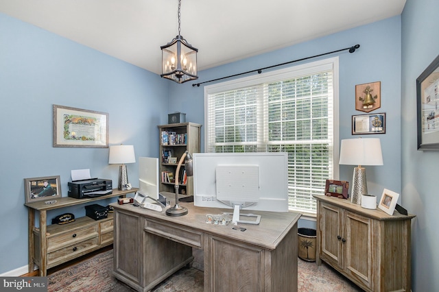 office area with a chandelier and baseboards