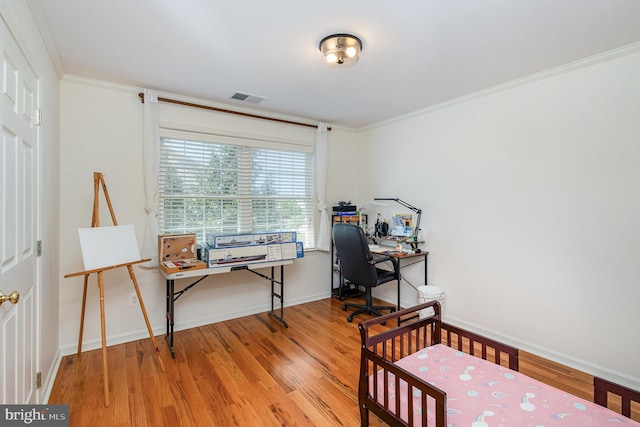bedroom with visible vents, wood finished floors, and ornamental molding
