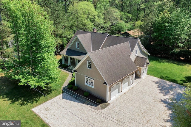aerial view of property and surrounding area with a forest