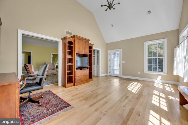 home office featuring high vaulted ceiling, light wood-type flooring, a chandelier, and baseboards