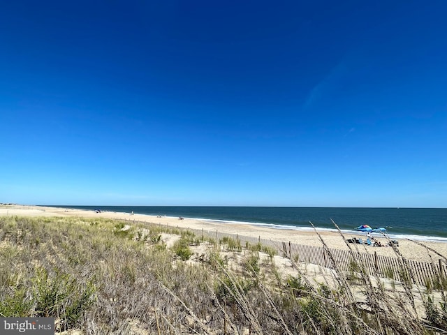 water view featuring fence and local beach