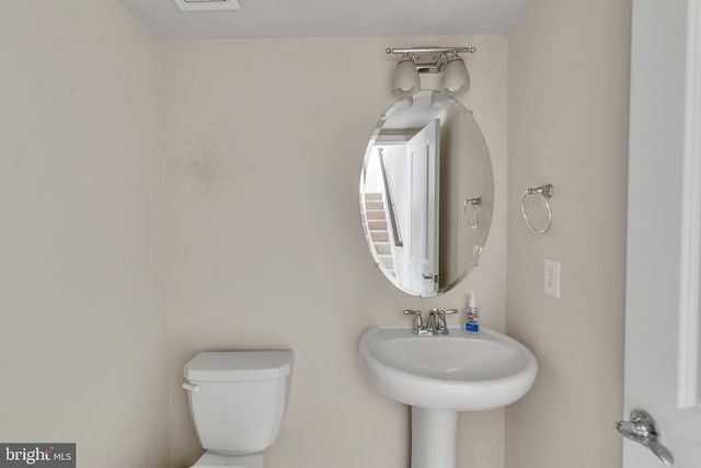 bathroom featuring toilet and a sink