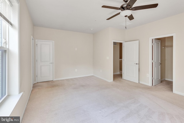 unfurnished bedroom with baseboards, ceiling fan, and light carpet