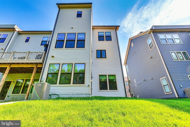 back of property featuring a lawn and a wooden deck