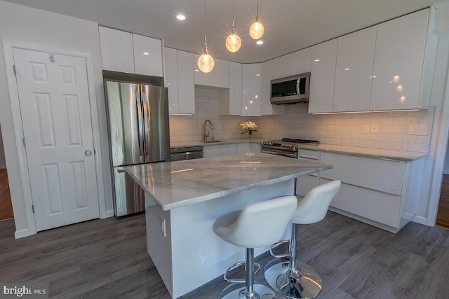 kitchen featuring stainless steel appliances, white cabinetry, and modern cabinets