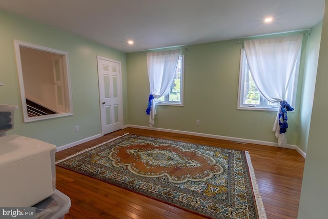 interior space with recessed lighting, a wealth of natural light, and hardwood / wood-style flooring