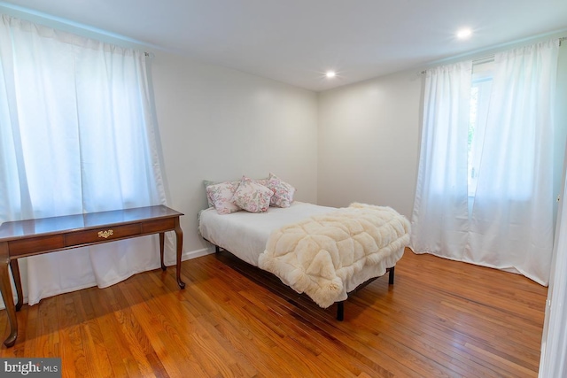 bedroom with recessed lighting and wood finished floors