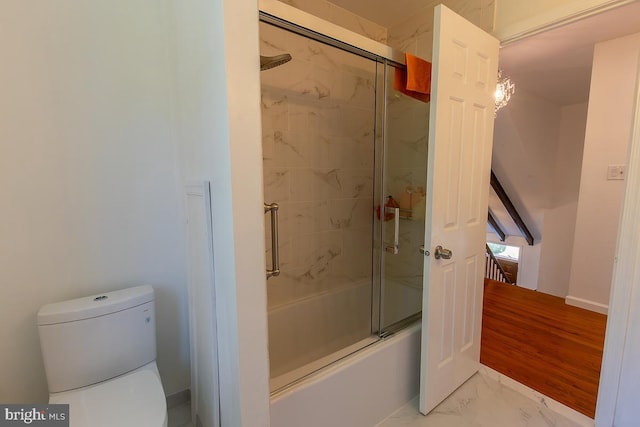 full bathroom with toilet, enclosed tub / shower combo, and marble finish floor
