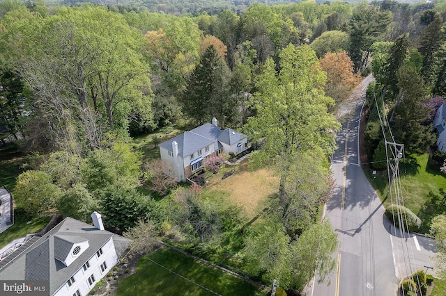 birds eye view of property featuring a view of trees