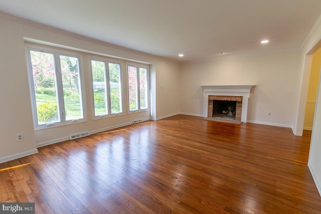 unfurnished living room with plenty of natural light, hardwood / wood-style flooring, and visible vents