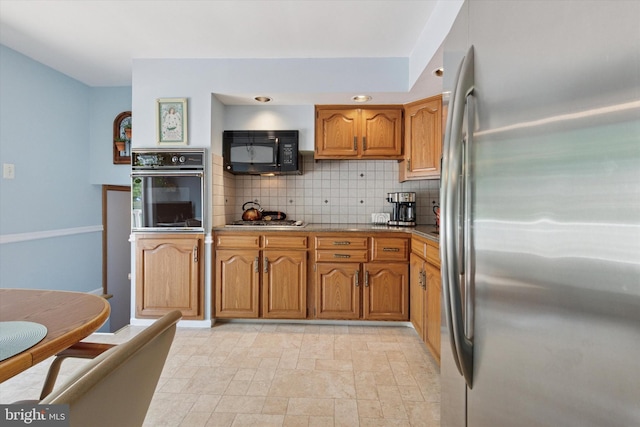 315 Waverly Rd, Southampton, PA 18966 - kitchen featuring black appliances, brown cabinetry, decorative backsplash, and light stone finish floors