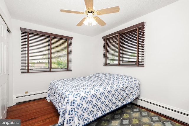 221 Orchard Ave, Burlington, NJ 08016 - bedroom featuring a closet, ceiling fan, a baseboard heating unit, and wood finished floors
