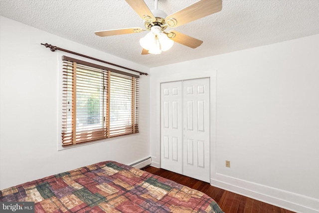 221 Orchard Ave, Burlington, NJ 08016 - bedroom with dark wood-style flooring, a textured ceiling, baseboards, a baseboard radiator, and a closet
