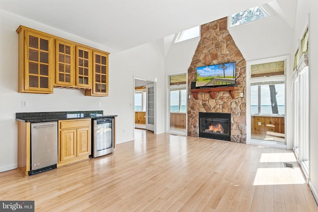 40461 Old Breton Beach Rd, Leonardtown, MD 20650 - kitchen with beverage cooler, light wood-style flooring, plenty of natural light, glass insert cabinets, and high vaulted ceiling