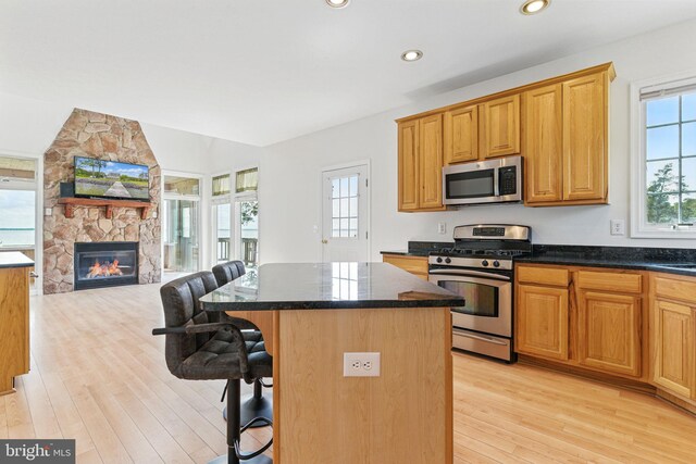 40461 Old Breton Beach Rd, Leonardtown, MD 20650 - kitchen with stainless steel appliances, open floor plan, a kitchen bar, light wood finished floors, and a center island