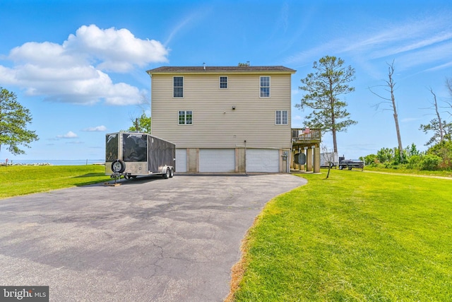 40461 Old Breton Beach Rd, Leonardtown, MD 20650 - back of house featuring a garage, a yard, asphalt driveway, and a deck