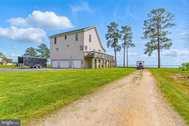 40461 Old Breton Beach Rd, Leonardtown, MD 20650 - back of house with driveway, a lawn, a garage, and a deck