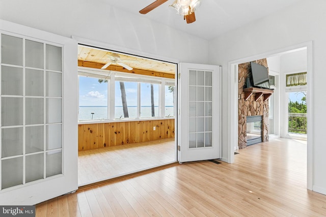 40461 Old Breton Beach Rd, Leonardtown, MD 20650 - doorway to outside featuring a ceiling fan, wood-type flooring, and a stone fireplace