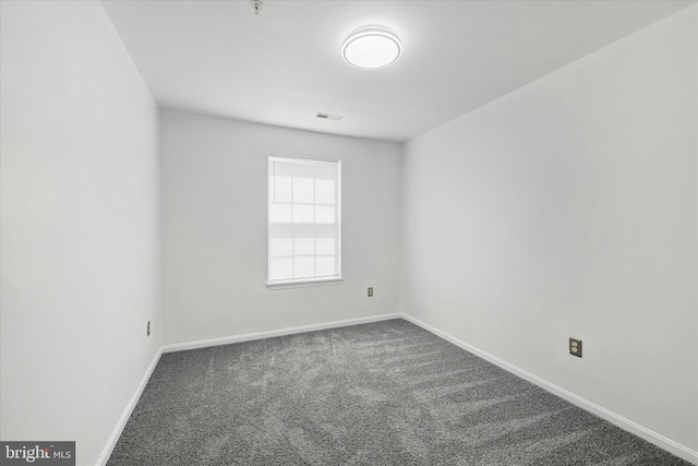carpeted empty room with baseboards and visible vents