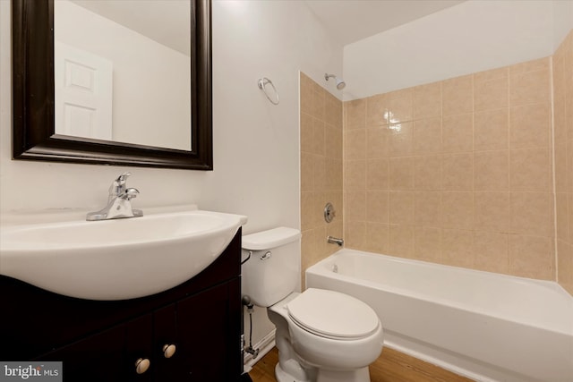 bathroom with shower / bathtub combination, vanity, toilet, and wood finished floors