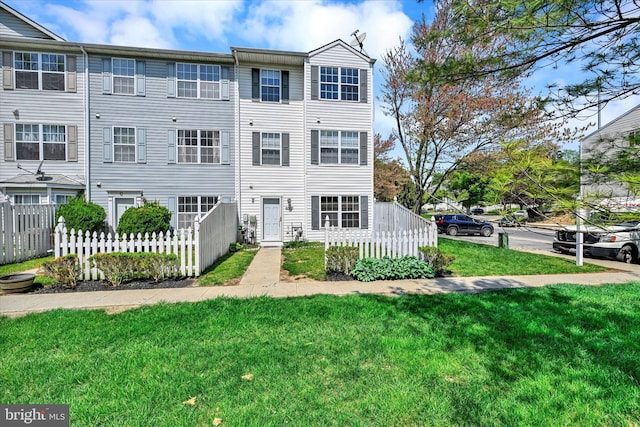 view of property with fence and a front yard