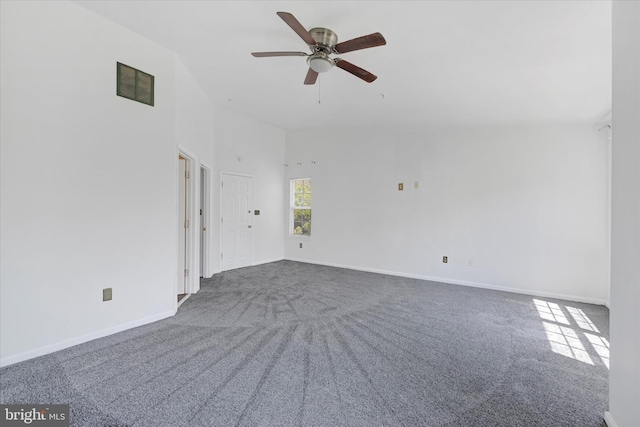 spare room featuring ceiling fan, visible vents, baseboards, and carpet