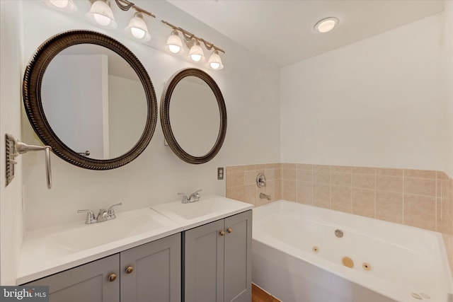 full bath featuring a jetted tub, a sink, and double vanity