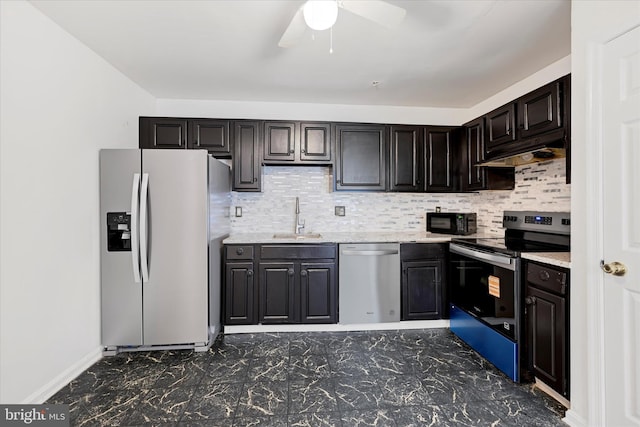kitchen featuring decorative backsplash, a ceiling fan, under cabinet range hood, a sink, and stainless steel appliances