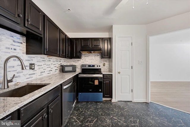 kitchen featuring a sink, tasteful backsplash, light stone countertops, and stainless steel appliances