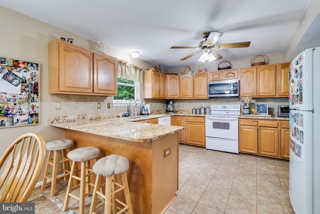 75 NW Dr, Huntingtown, MD 20639 - kitchen featuring white appliances, a peninsula, a sink, backsplash, and a ceiling fan