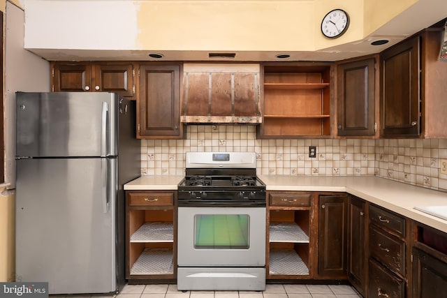 kitchen with light countertops, open shelves, backsplash, and stainless steel appliances