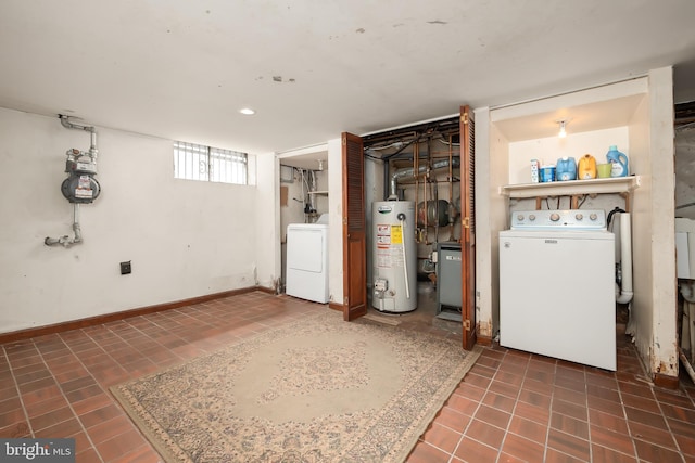 laundry area with tile patterned flooring, washer / clothes dryer, and gas water heater