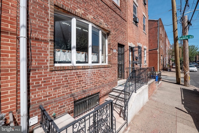 view of side of home with brick siding