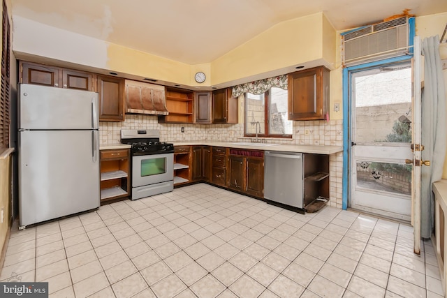 kitchen featuring open shelves, wall chimney range hood, light countertops, a sink, and stainless steel appliances