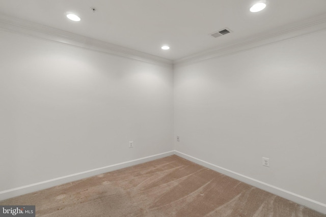 spare room with crown molding, light colored carpet, baseboards, recessed lighting, and a pendent fire sprinkler