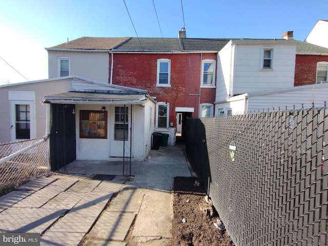 615 Lake St, Lancaster, PA 17603 - back of house with a patio, a fenced backyard, and brick siding