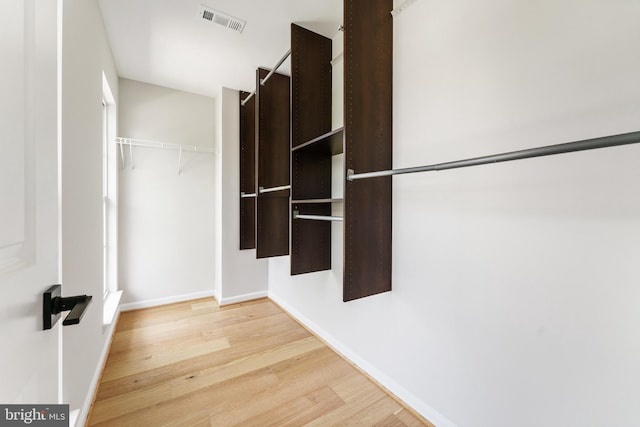 walk in closet featuring visible vents and light wood finished floors