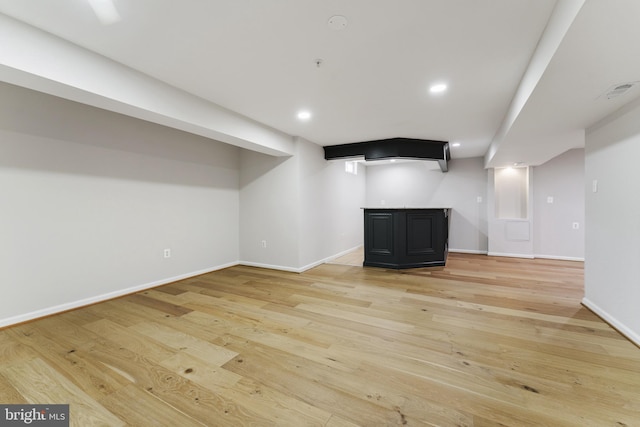 finished basement with recessed lighting, baseboards, and light wood-style floors