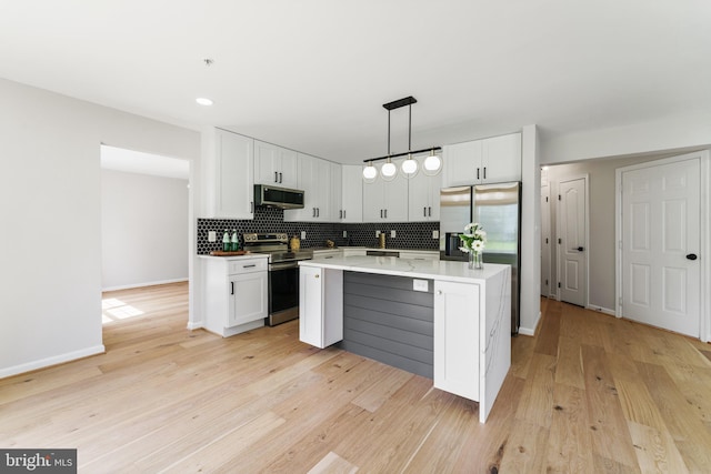 kitchen with tasteful backsplash, stainless steel appliances, and white cabinetry