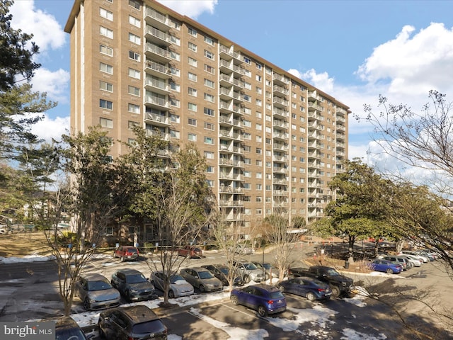 view of building exterior with uncovered parking