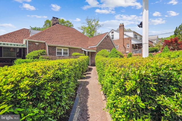 5506 39th Ave, Hyattsville, MD 20781 - view of front of home with brick siding, a shingled roof, and a chimney