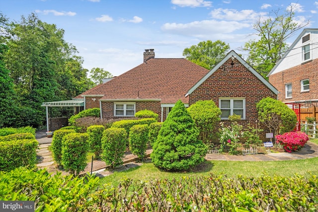 5506 39th Ave, Hyattsville, MD 20781 - view of front facade with brick siding, a chimney, fence, a pergola, and a shingled roof