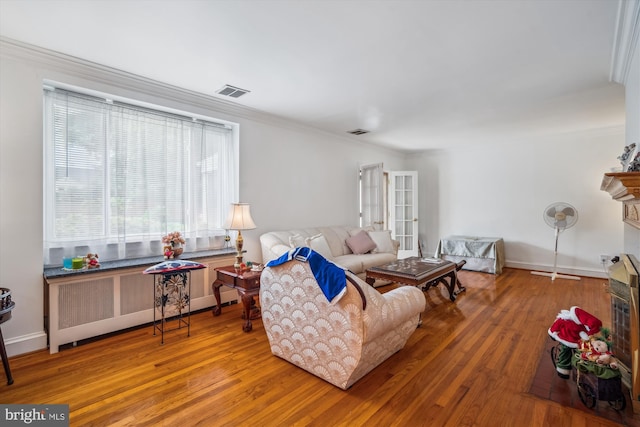 5506 39th Ave, Hyattsville, MD 20781 - living area featuring radiator heating unit, hardwood / wood-style flooring, ornamental molding, baseboards, and a fireplace