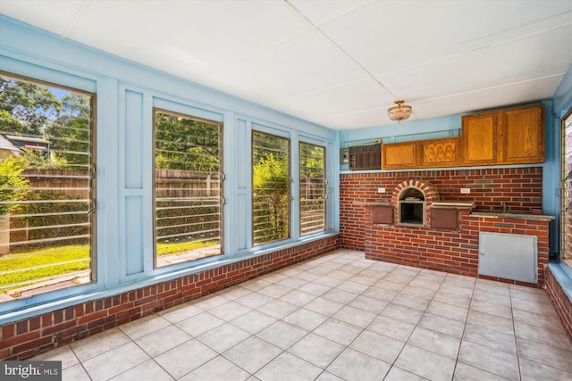5506 39th Ave, Hyattsville, MD 20781 - unfurnished sunroom with brick wall, tile patterned flooring, and an AC wall unit